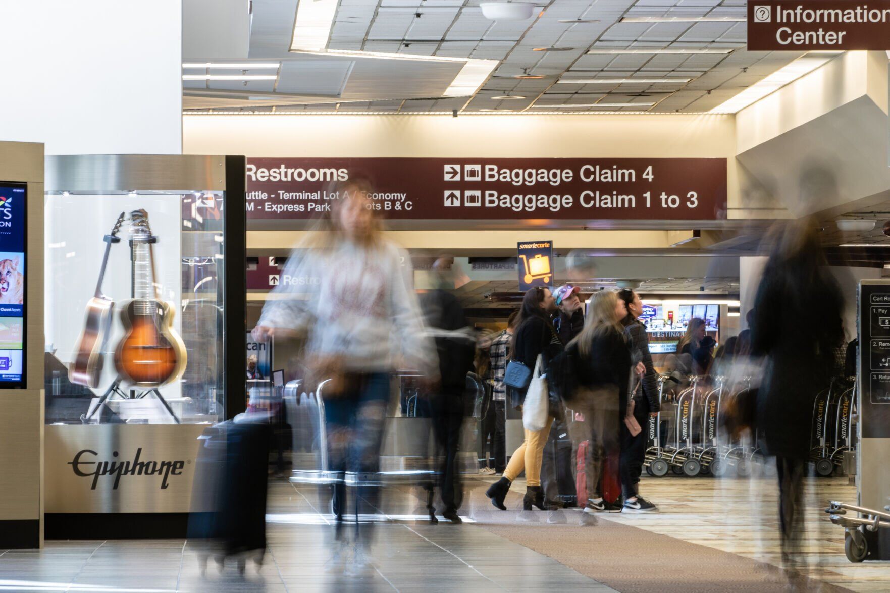 People in motion in the baggage claim area at Nashville International Airport (BNA)